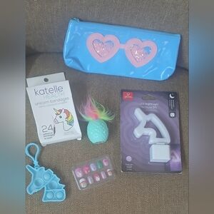 6: unicorn- nightlight,fidget pop keychain,lippie,bandaids,nails,pouch